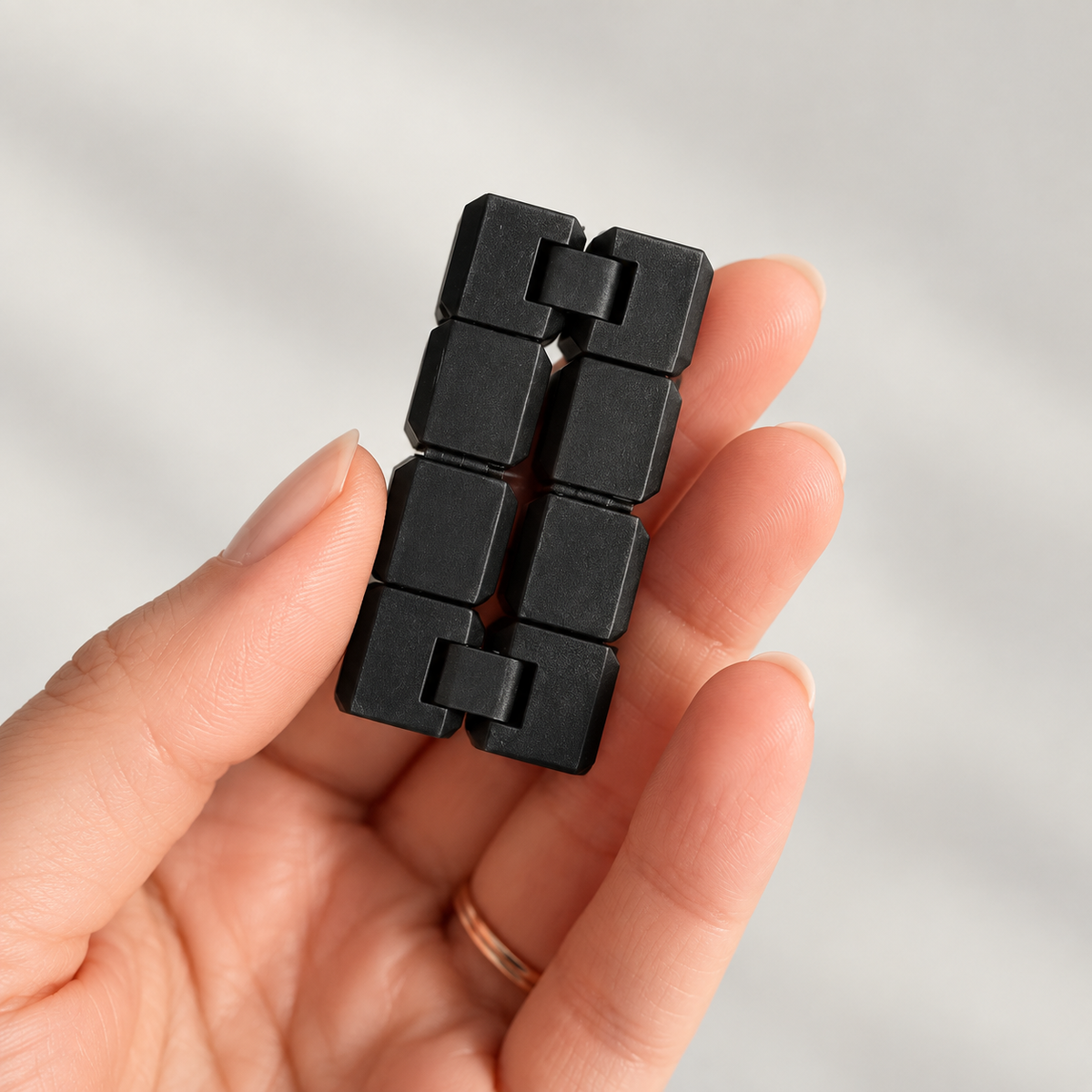 Black mini infinity cube fidget opened in hand
