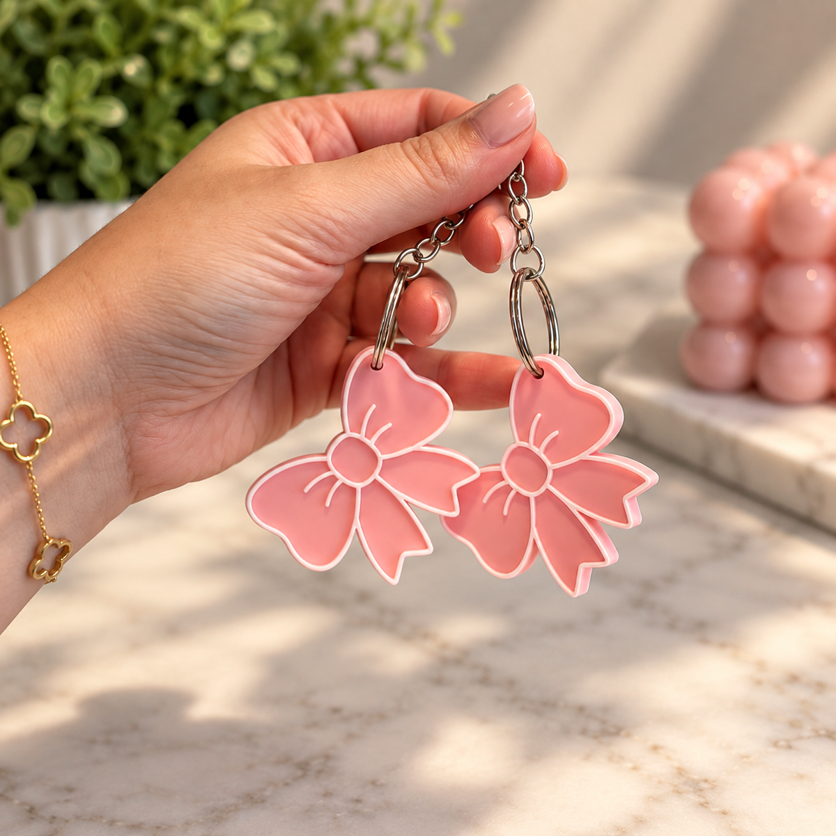 Pink 3D printed bow keychains with silver key rings