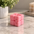 Pink 3D printed flexi cube fidget on a clean styled surface