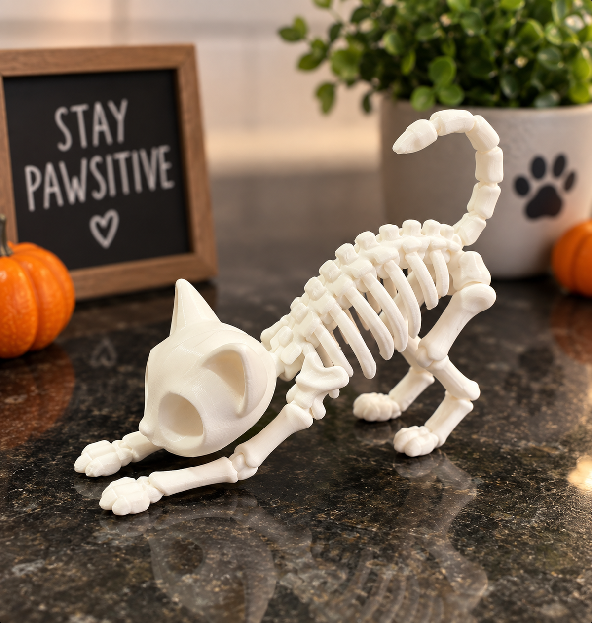 White 3D printed skeleton cat figure in a cozy Halloween display